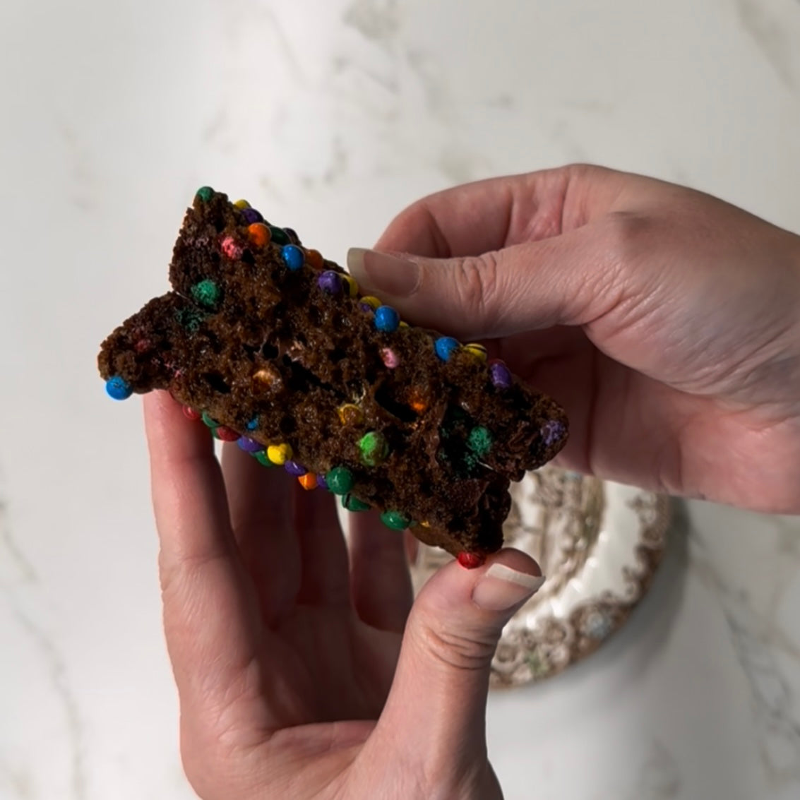 Dino-mite Cosmic Cookie broken open to show a soft chocolate center